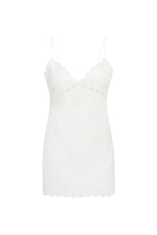 Linen mini dress with a fitted silhouette, thin spaghetti straps, cut outs at the top, scallop edges at the waist and a center back zipper.