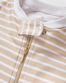 The Baby's Pima Romper in Camel Stripe features beige and white stripes, long sleeves, white cuffs, and a matching neck bow, shown flat on a white background.