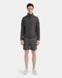 A man stands facing forward, wearing the Rudsak RAGAB - 6124577 Grey men’s hybrid jacket, paired with matching gray shorts and white sneakers, against a plain white background.