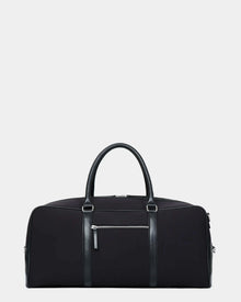 The Rudsak OLIVER - 9323507 Black is a unisex duffel bag with leather handles and trim, a front zippered pocket, and a minimalist design—an ideal luxury travel companion, shown against a plain white background.